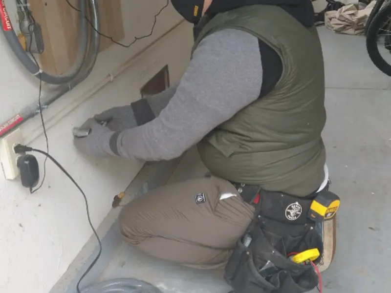 Electrician performing outlet wiring in a Briar Chapel garage