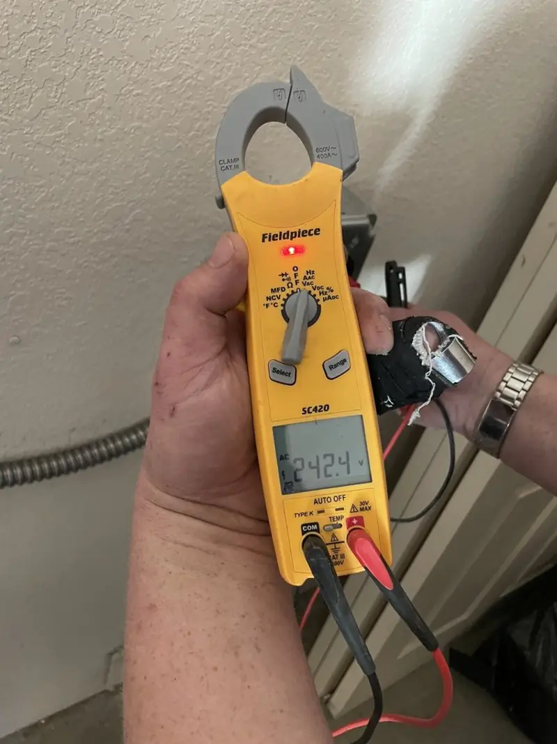 Voltage testing with clamp meter during Recessed Lighting Installation in Briar Chapel